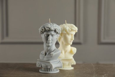 Photo of Beautiful David bust candles on grey table