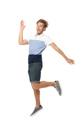 Photo of Young man in casual clothes jumping on white background