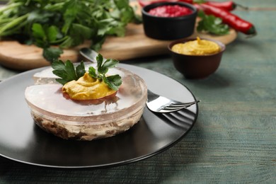 Plate with delicious aspic on light blue wooden table