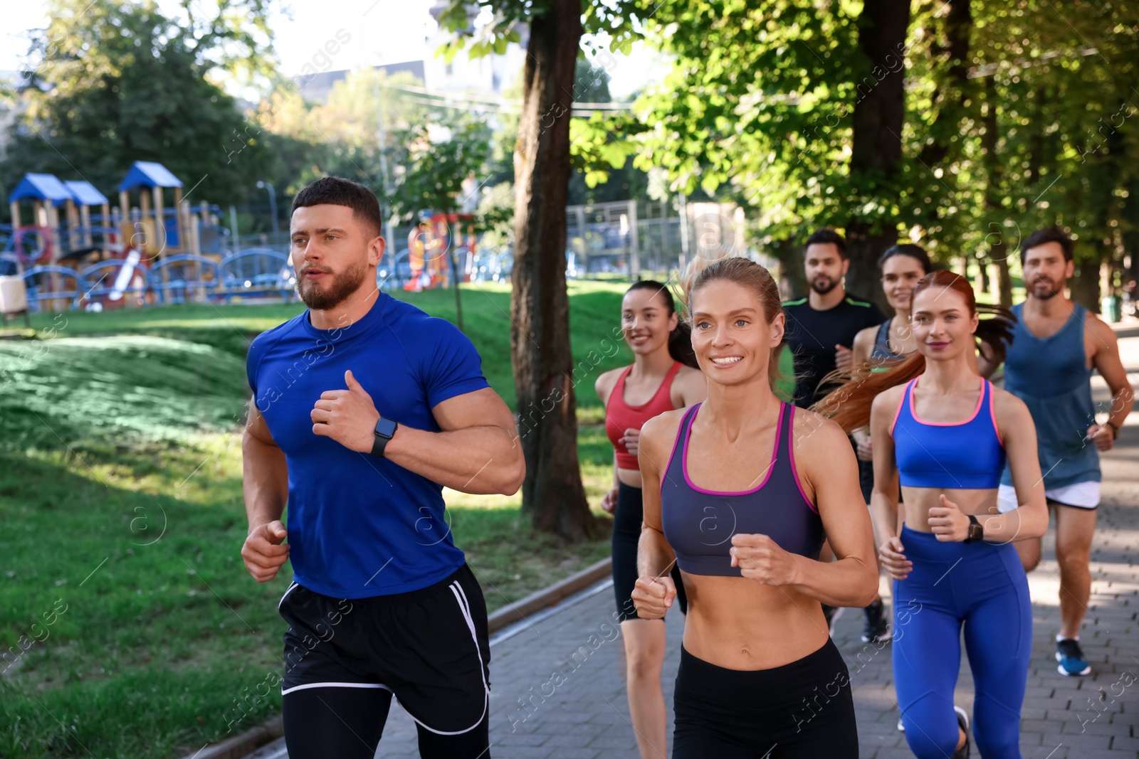 Photo of Group of people running in park. Active lifestyle