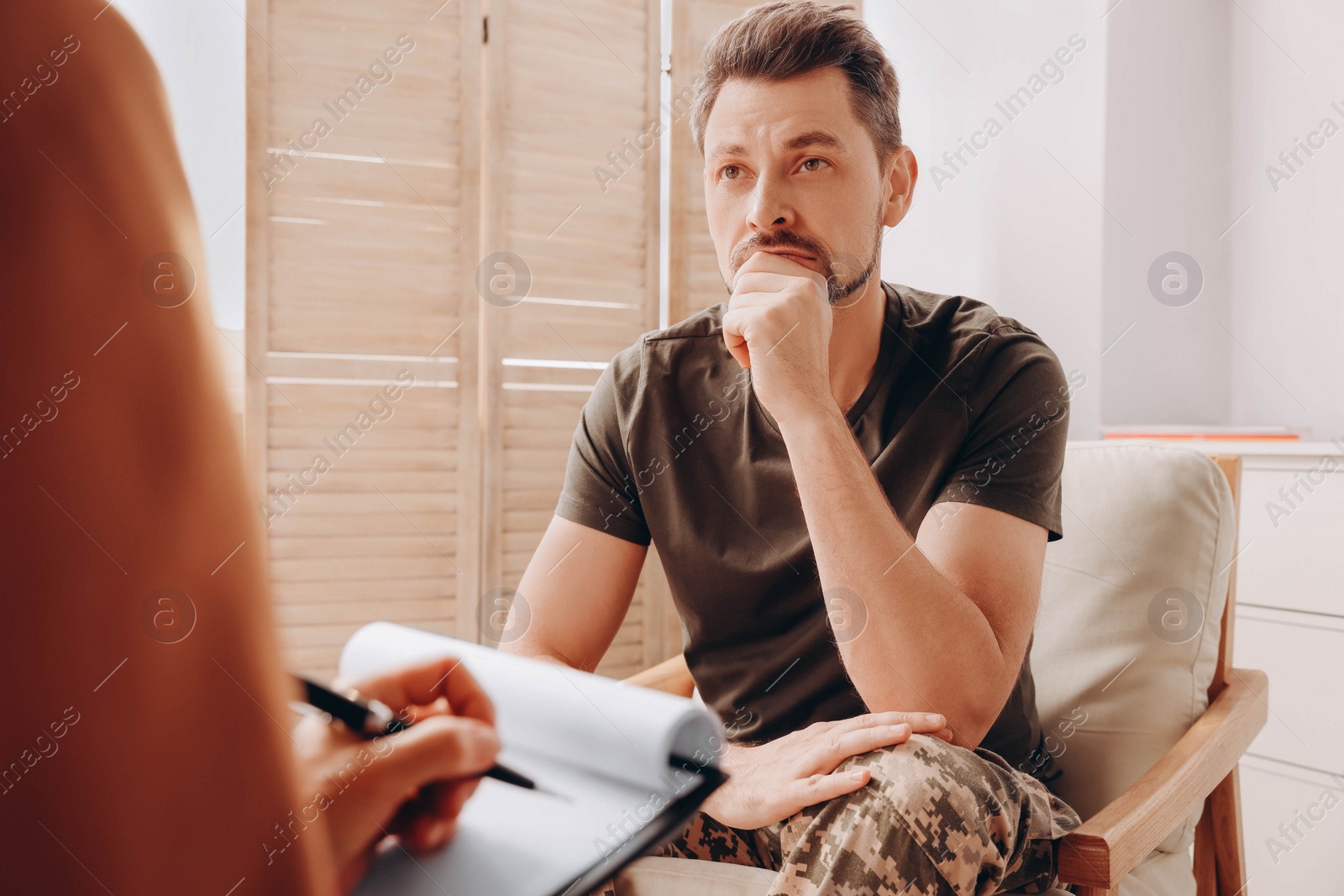 Photo of Psychologist working with military officer in office