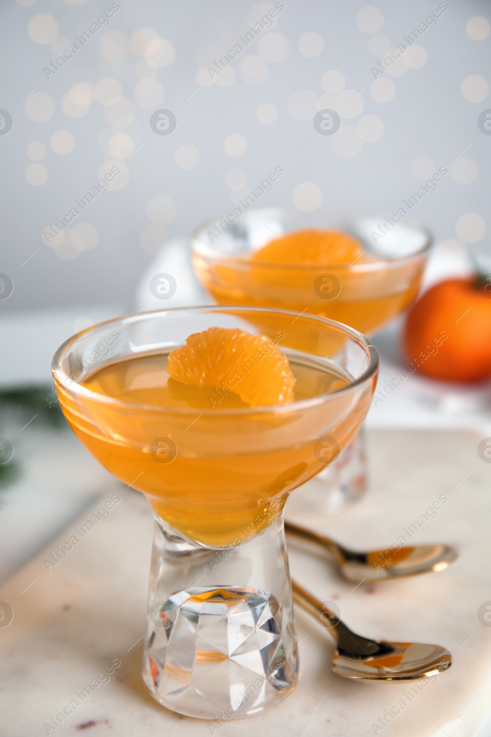 Photo of Delicious tangerine jelly on white marble board