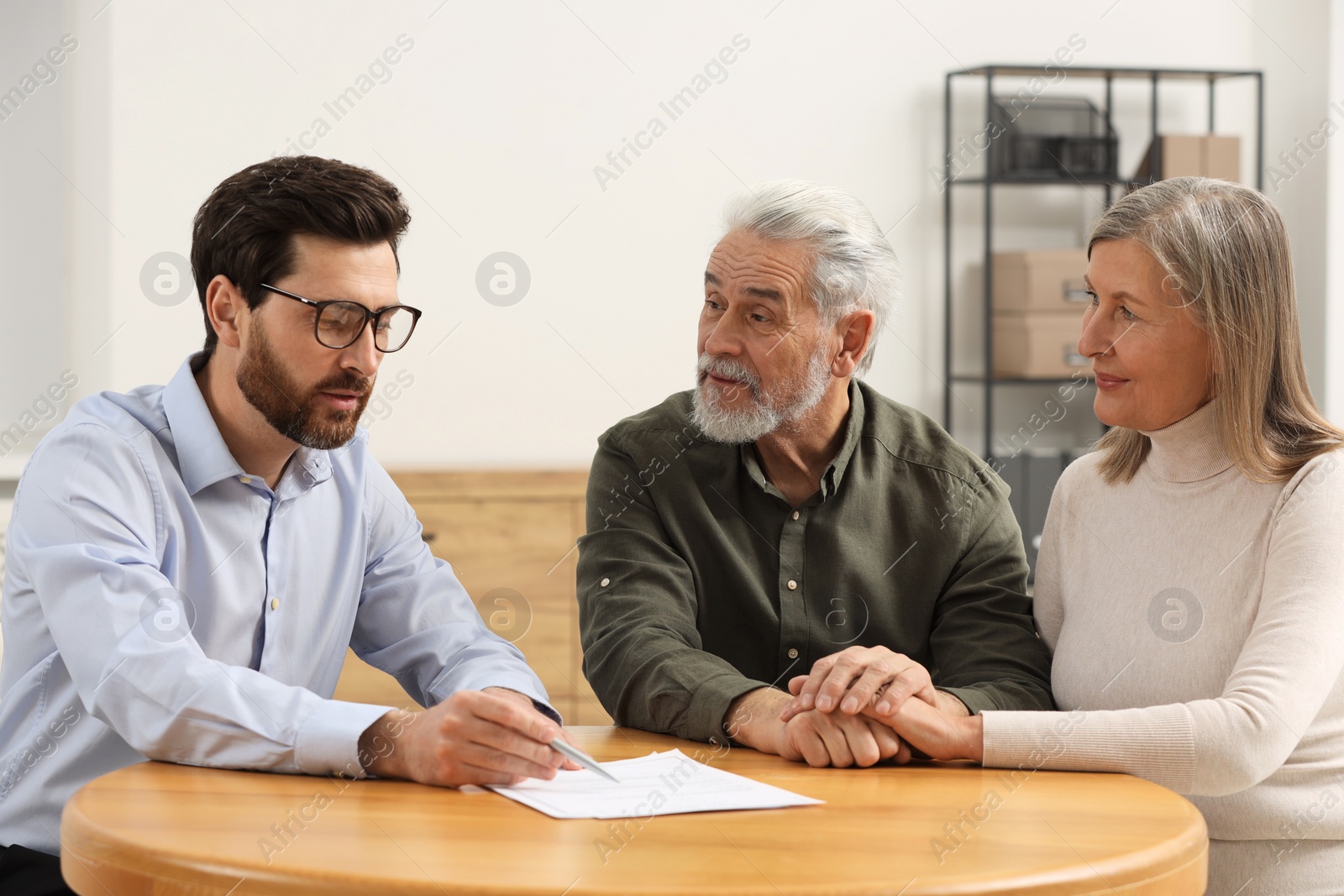 Photo of Notary consulting senior couple about Last Will and Testament in office