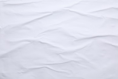 Photo of White crumpled sheet of paper as background, top view. Wall poster