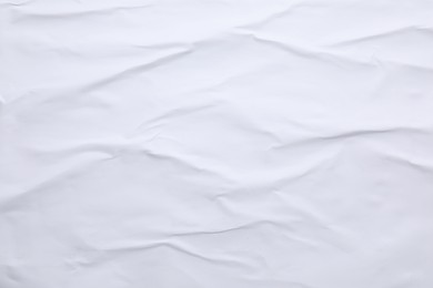 White crumpled sheet of paper as background, top view. Wall poster