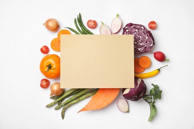 Flat lay composition with fresh vegetables and blank card for text on white background