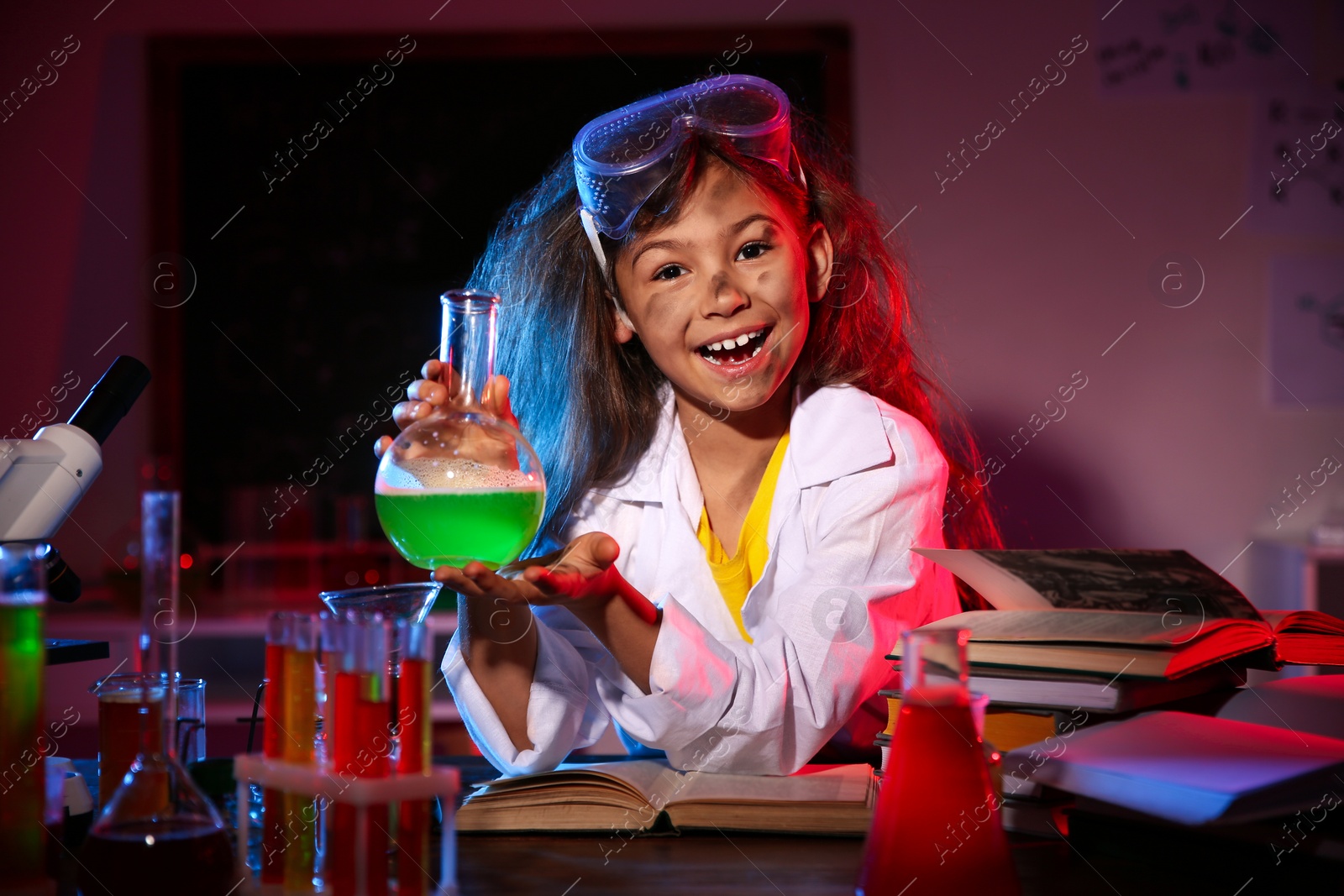 Photo of Child doing chemical research in laboratory. Dangerous experiment