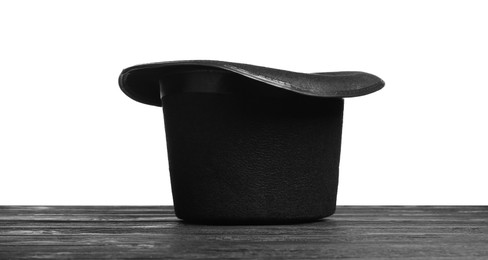 Photo of Magician's hat on wooden table against white background