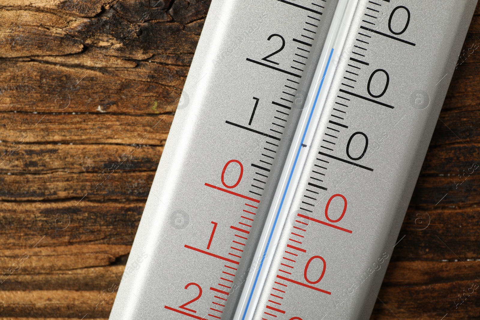 Photo of Modern weather thermometer on wooden background, closeup