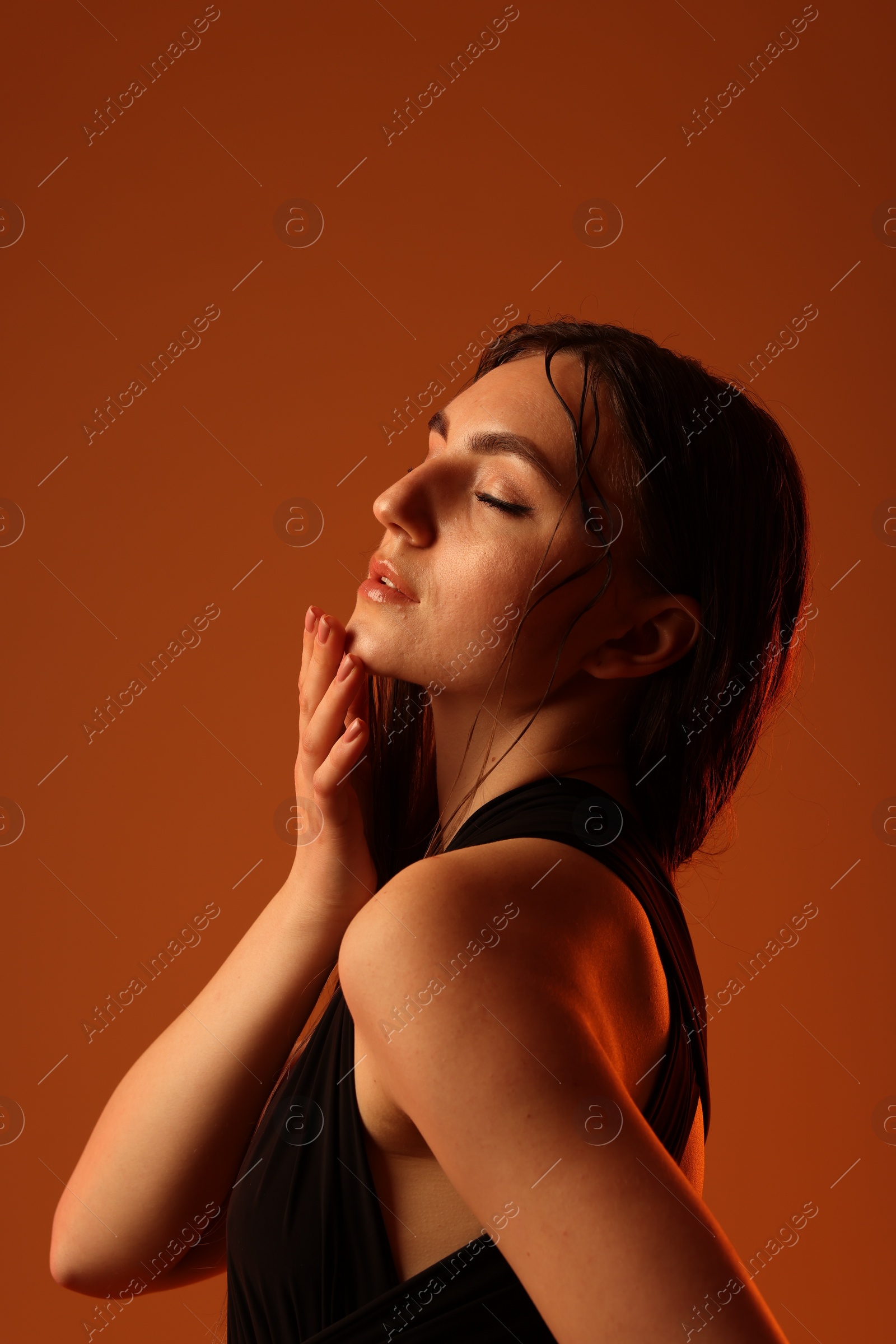 Photo of Portrait of beautiful woman on brown background