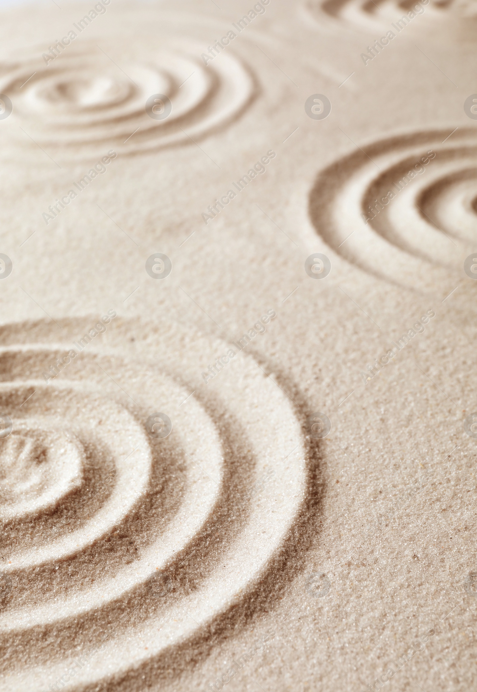 Photo of Zen garden pattern on sand. Meditation and harmony