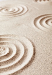 Photo of Zen garden pattern on sand. Meditation and harmony