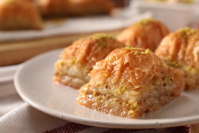 Delicious sweet baklava with pistachios on table, closeup