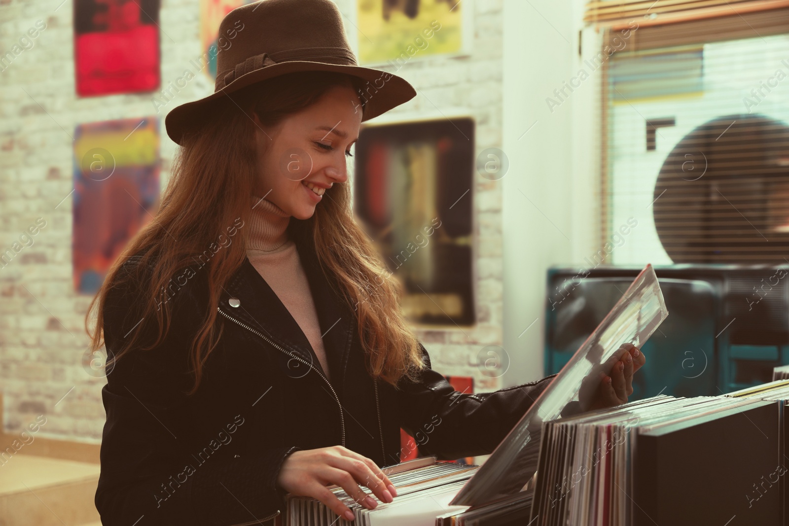 Image of Young woman with vinyl record in store