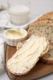 Tasty bread with butter on table, closeup