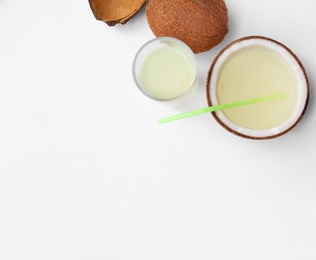 Composition with drink and coconuts on white background, top view