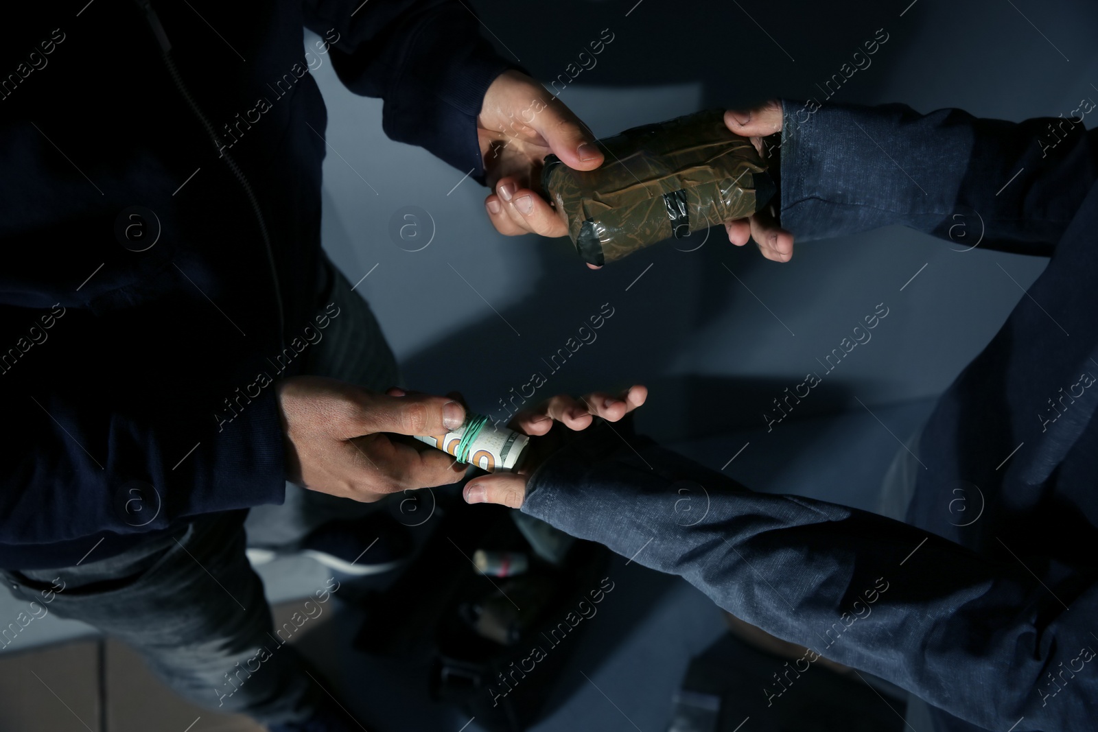 Photo of Addicted man buying drugs from dealer, focus on hands