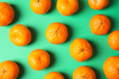 Flat lay composition with ripe tangerines on color background