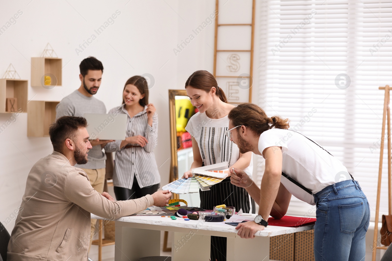 Photo of Fashion designers creating new clothes in studio