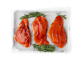 Raw marinated meat and rosemary isolated on white, top view
