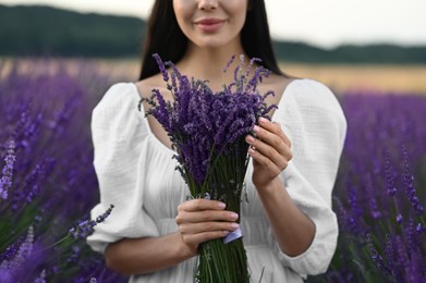 Photo of Woman with bouquet in lavender field, closeup