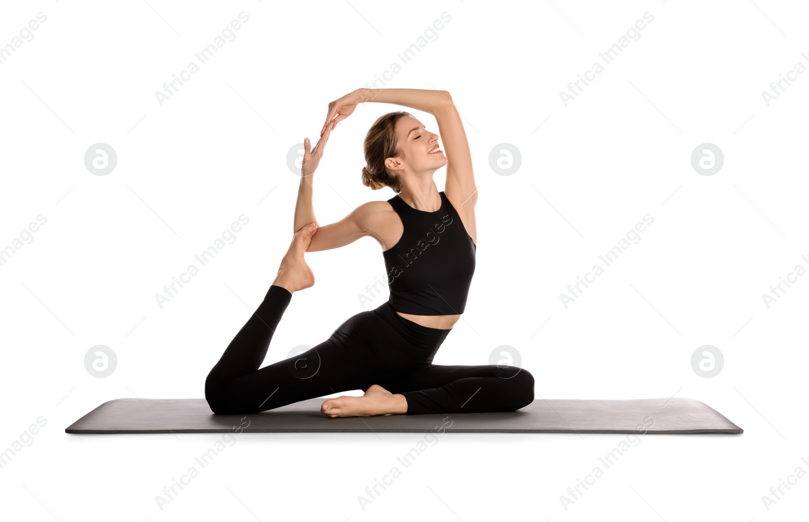 Photo of Young woman in sportswear practicing yoga on white background