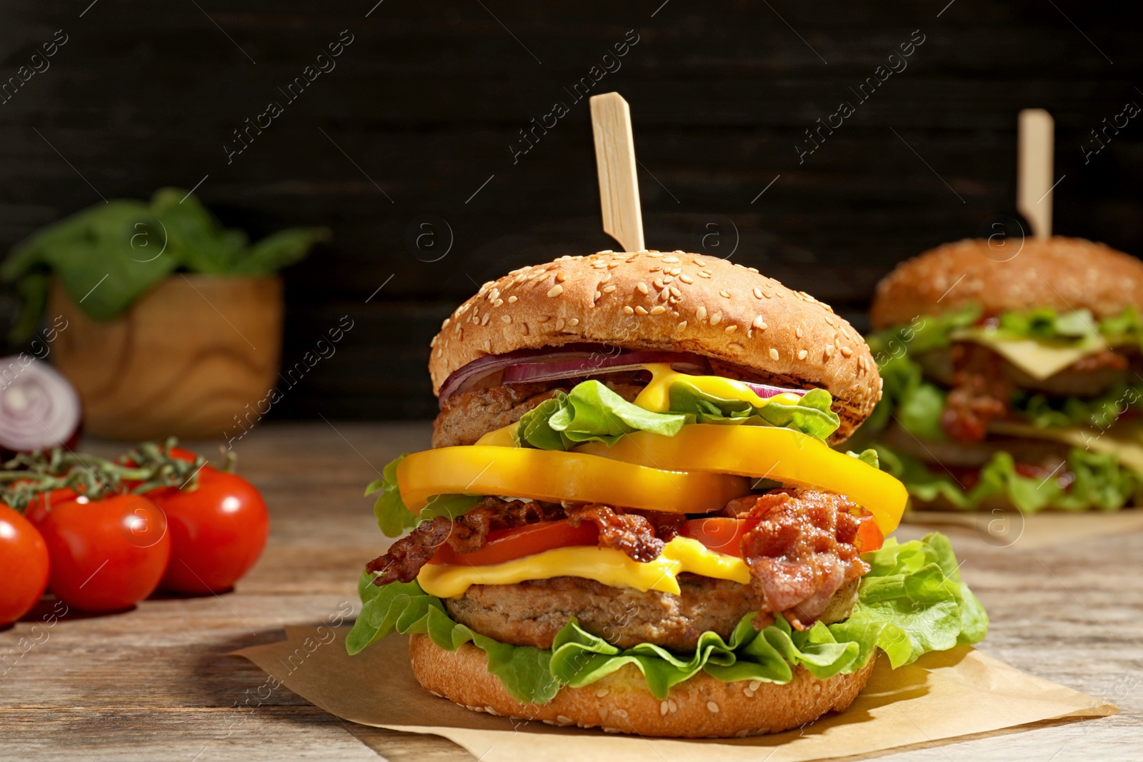 Photo of Tasty burger with bacon on table. Space for text