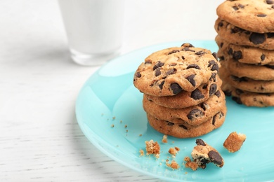 Photo of Plate with tasty chocolate cookies on light table