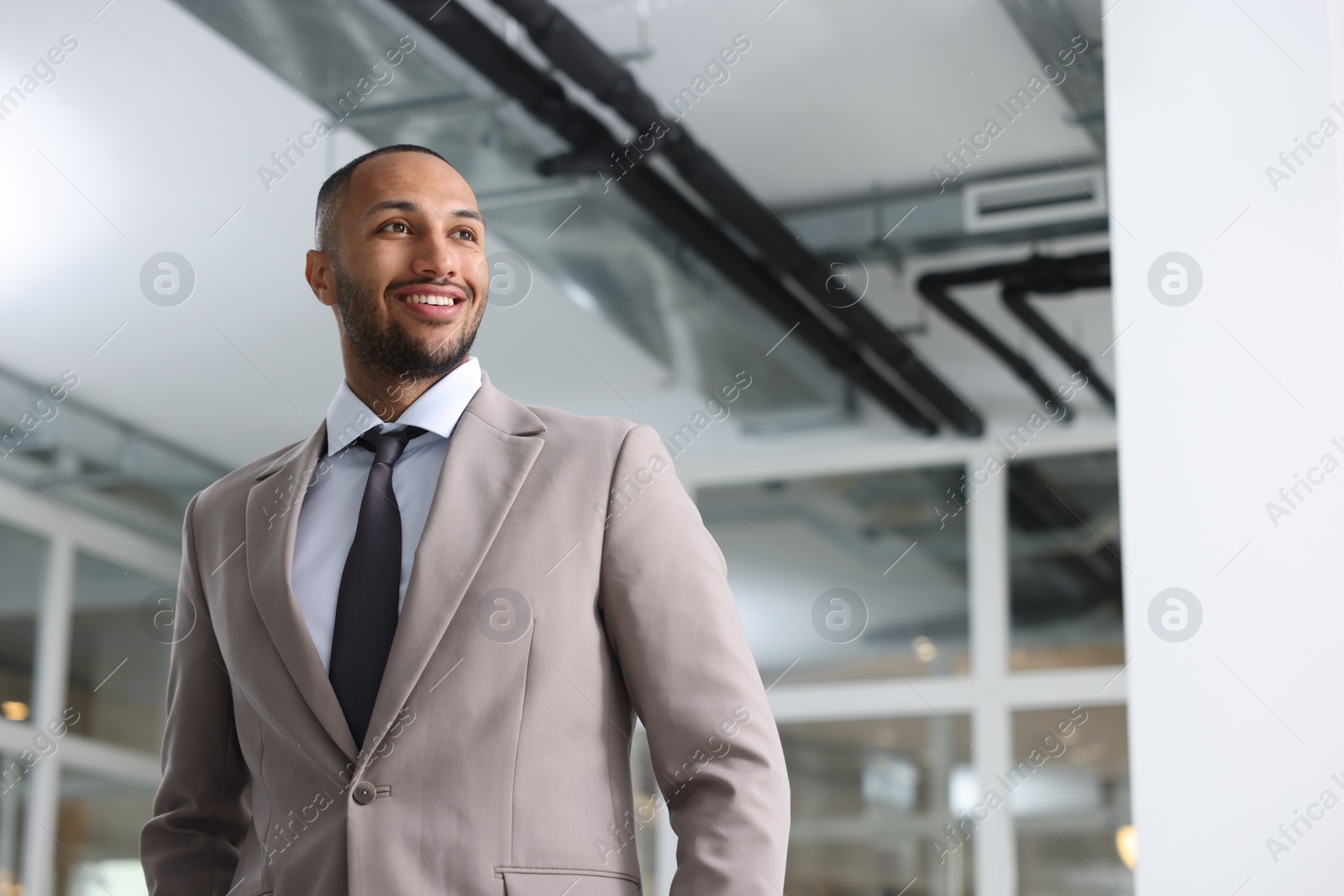 Photo of Happy man with crossed arms in office, space for text. Lawyer, businessman, accountant or manager