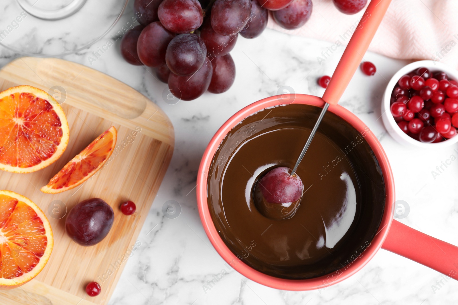 Photo of Flat lay composition with chocolate fondue on marble background