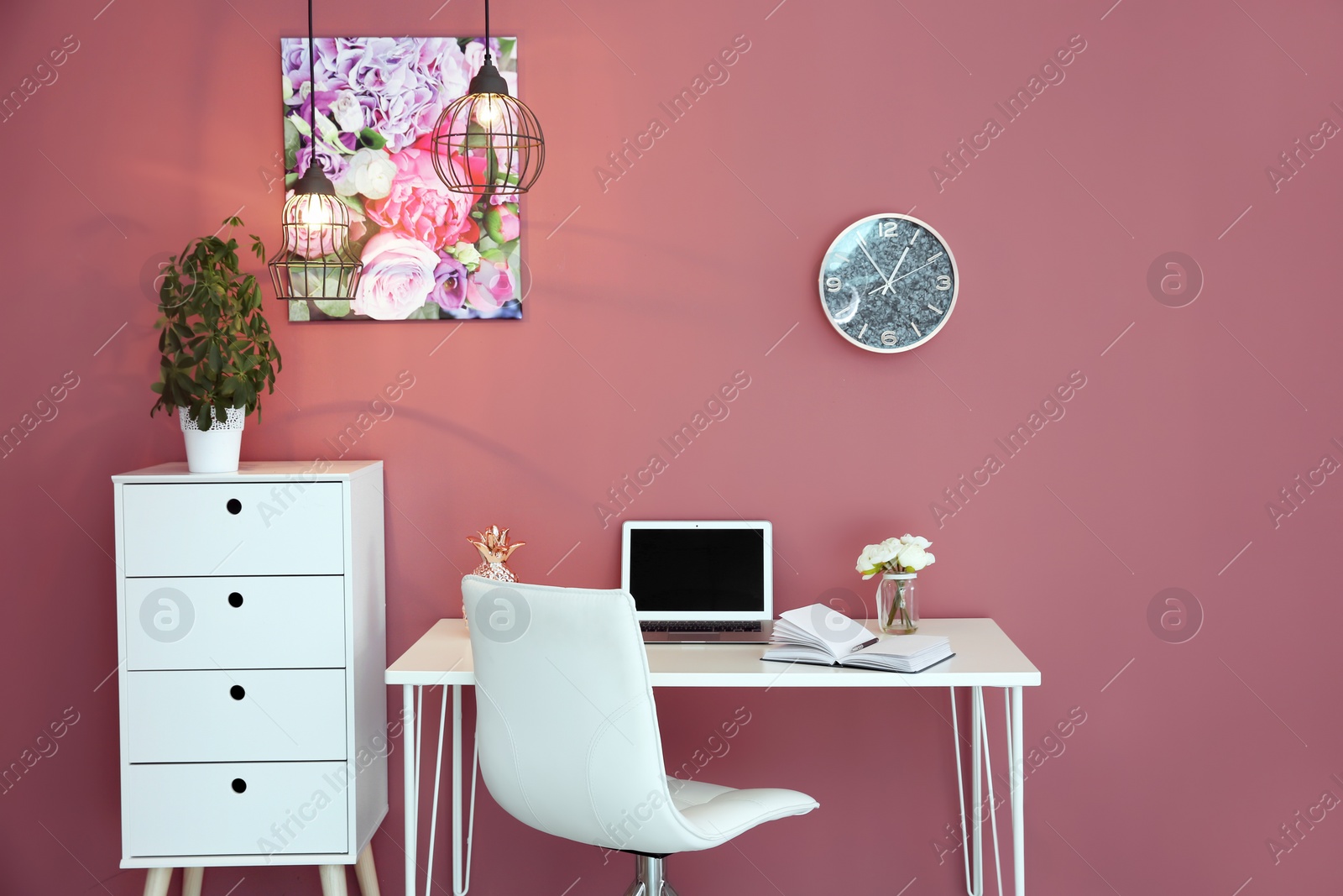 Photo of Stylish workplace interior with laptop on table