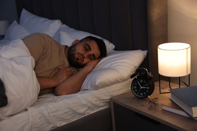 Photo of Frustrated man suffering from insomnia in bed