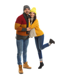 Photo of Happy young couple in warm clothes on white background. Winter vacation