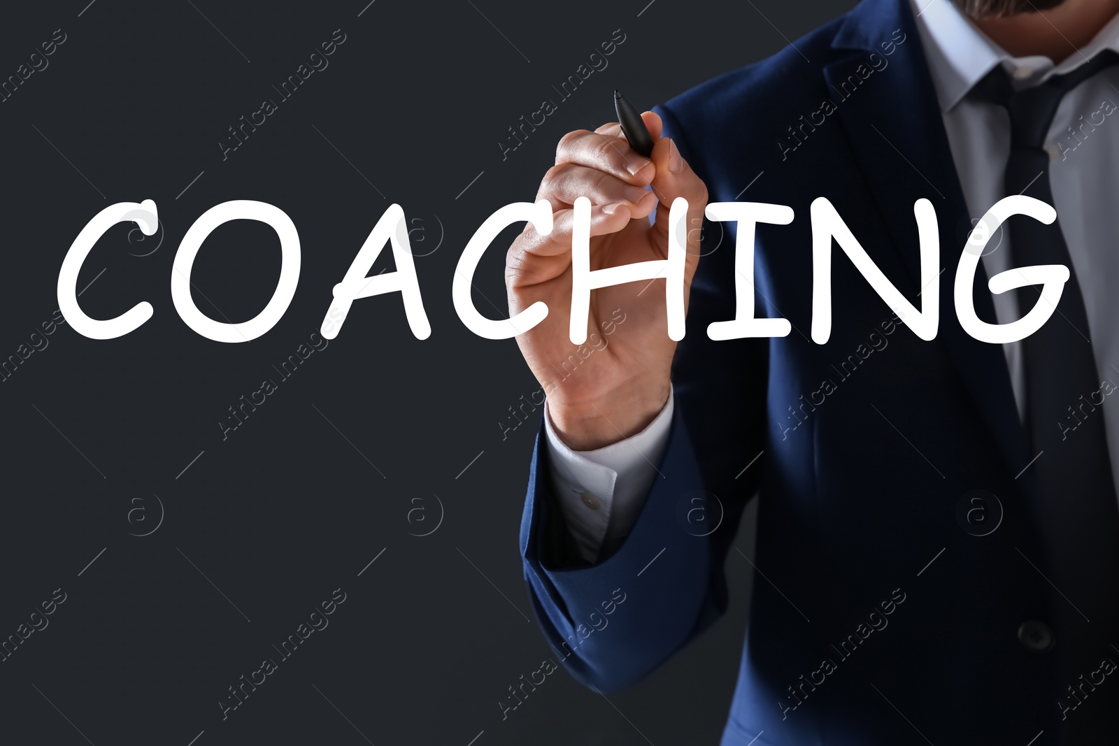 Image of Business trainer writing word Coaching on virtual screen, closeup