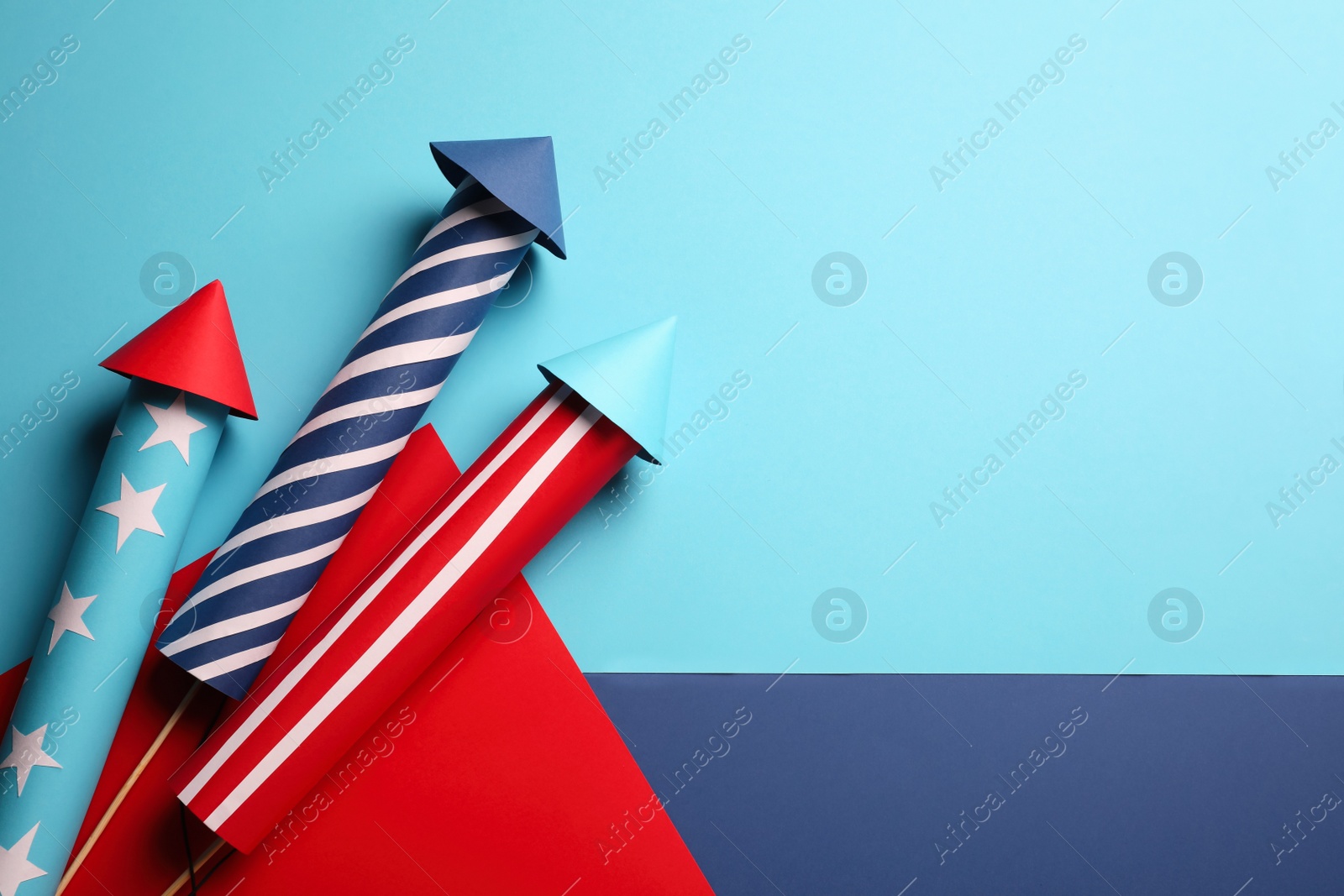 Photo of Firework rockets on color background, flat lay. Space for text