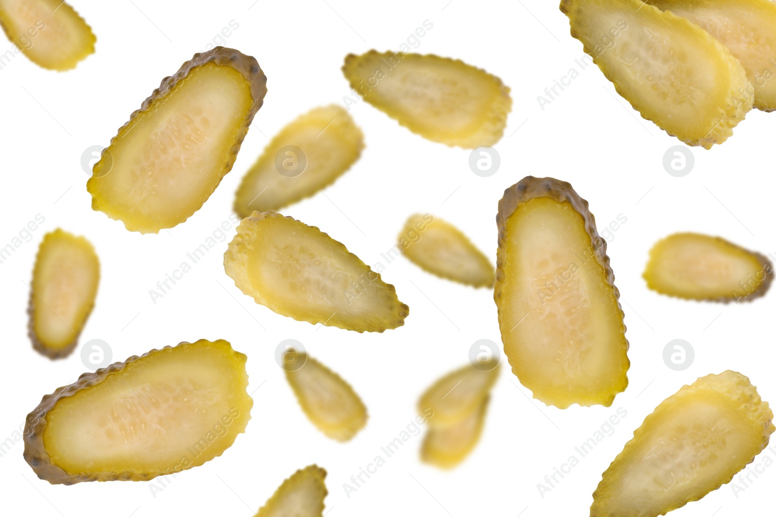 Image of Slices of tasty pickled cucumbers falling on white background