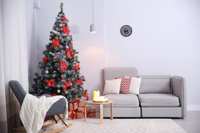 Photo of Stylish room interior with decorated Christmas tree