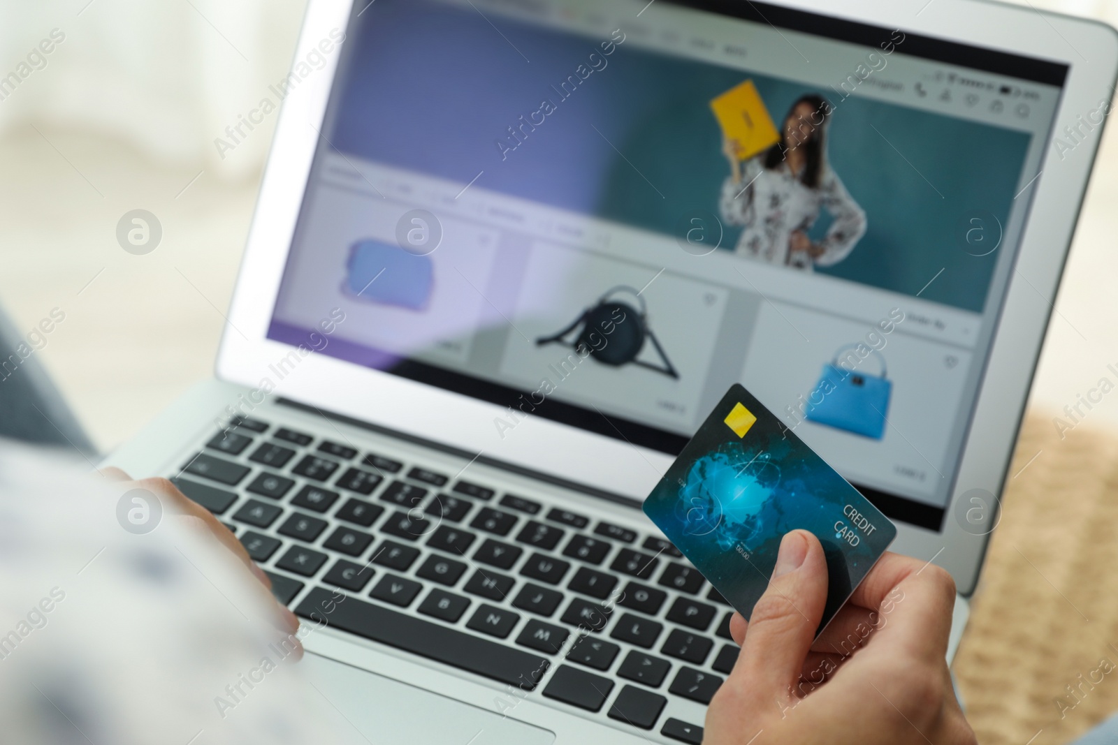 Photo of Woman with credit card using laptop for online shopping indoors, closeup