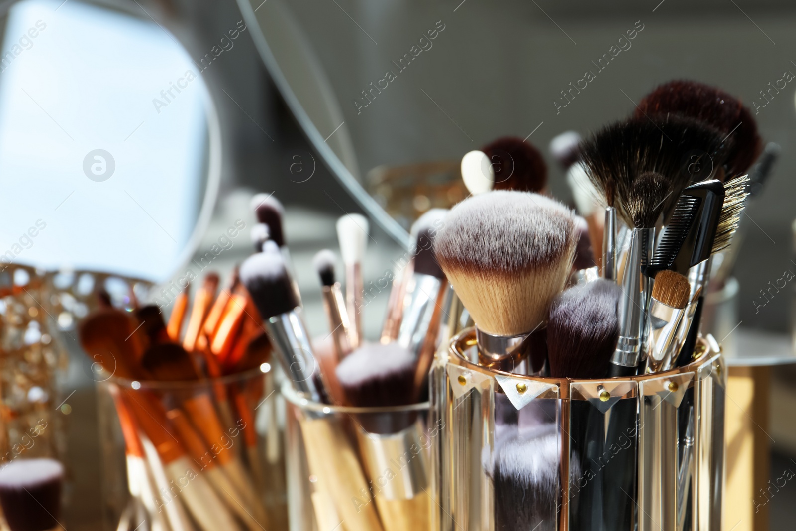 Photo of Set of professional brushes and mirror, closeup