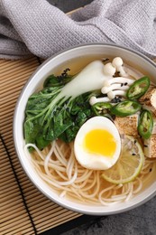 Photo of Bowl of vegetarian ramen on table, top view