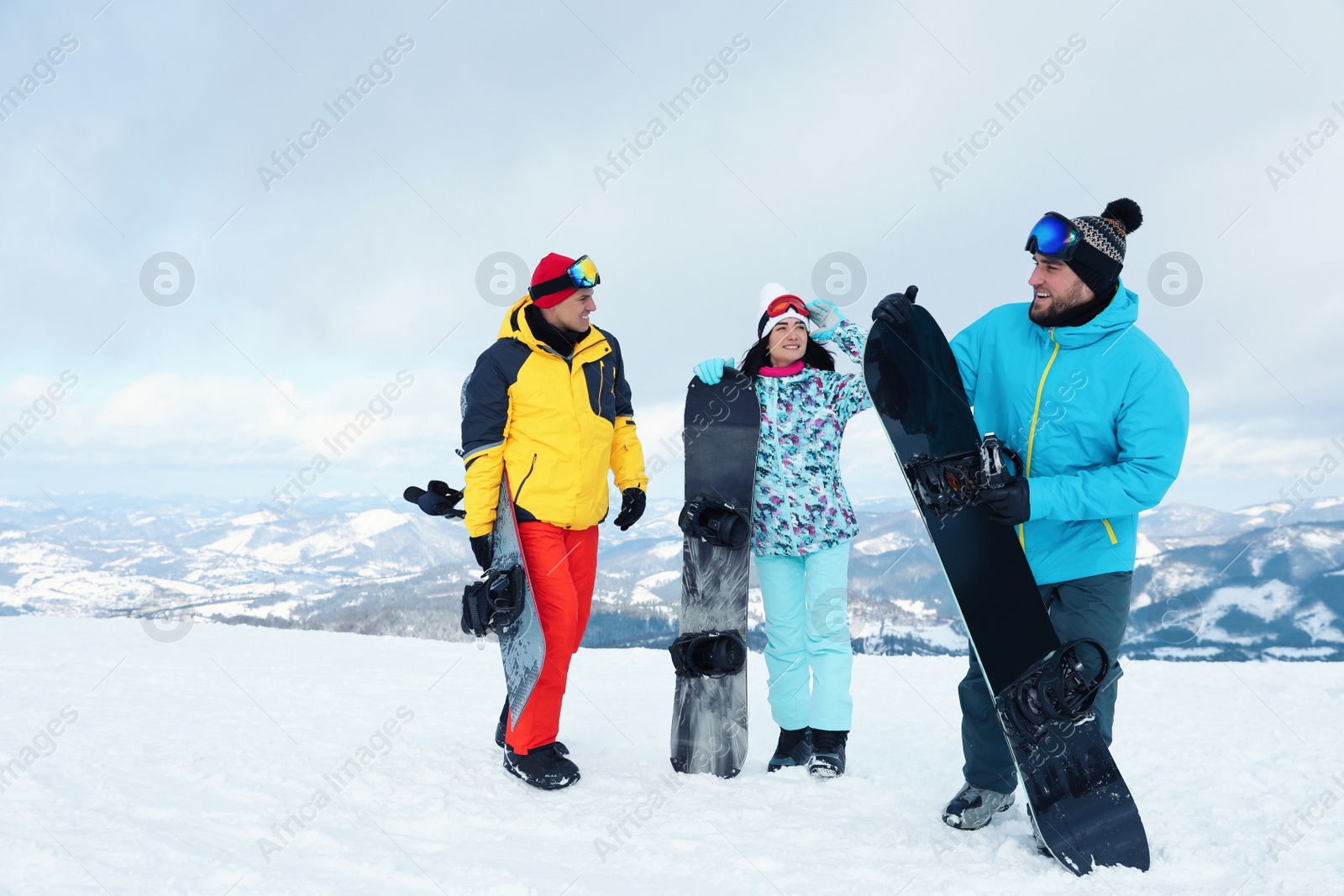 Photo of Group of friends with equipment in snowy mountains. Winter vacation