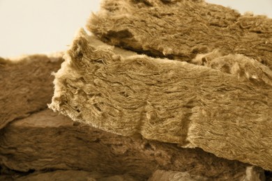 Photo of Heap of thermal insulation material on grey background, closeup