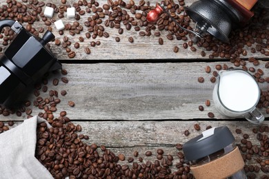 Photo of Flat lay composition with roasted coffee beans on wooden table. Space for text