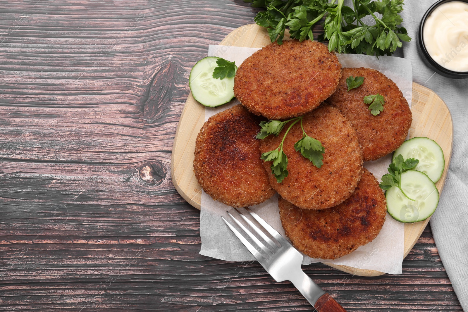 Photo of Tasty vegan cutlets served on wooden table, flat lay. Space for text