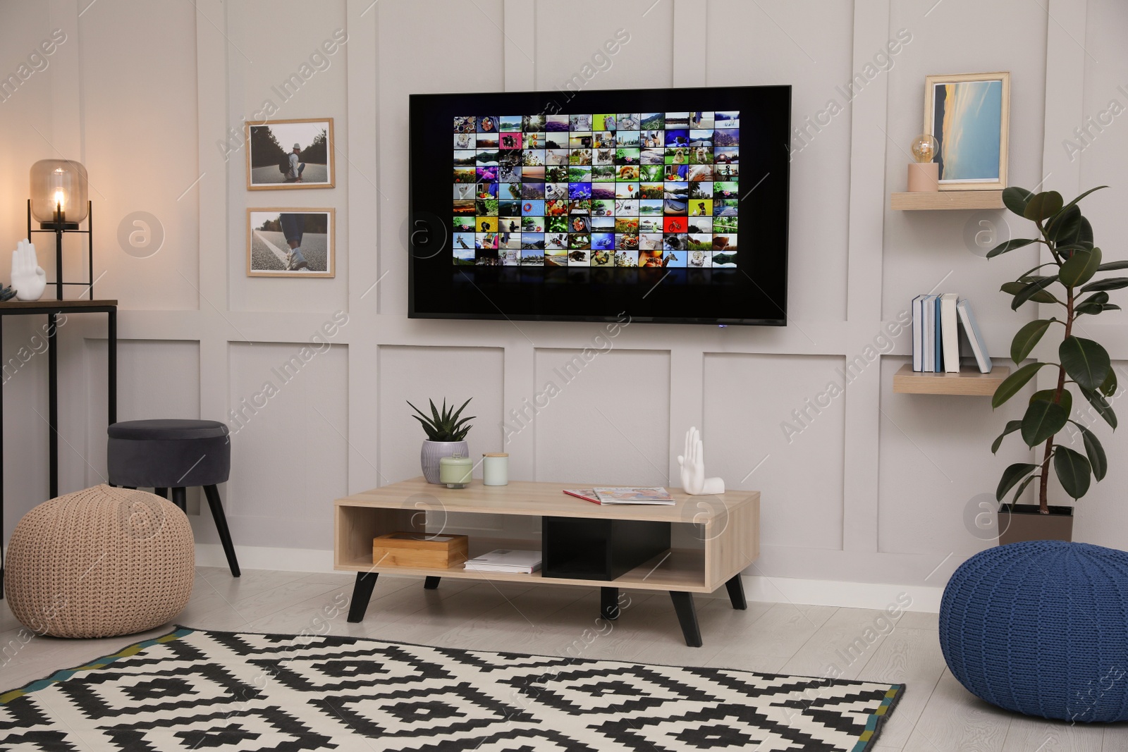 Photo of Stylish living room interior with modern TV on white wall