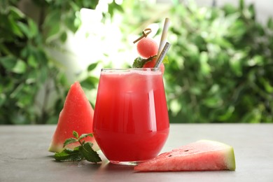 Photo of Delicious fresh watermelon drink on grey table