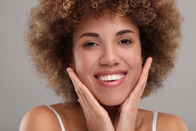 Photo of Beautiful woman with healthy skin on gray background