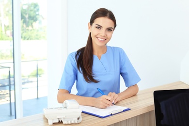 Female medical assistant at workplace in clinic. Health care service