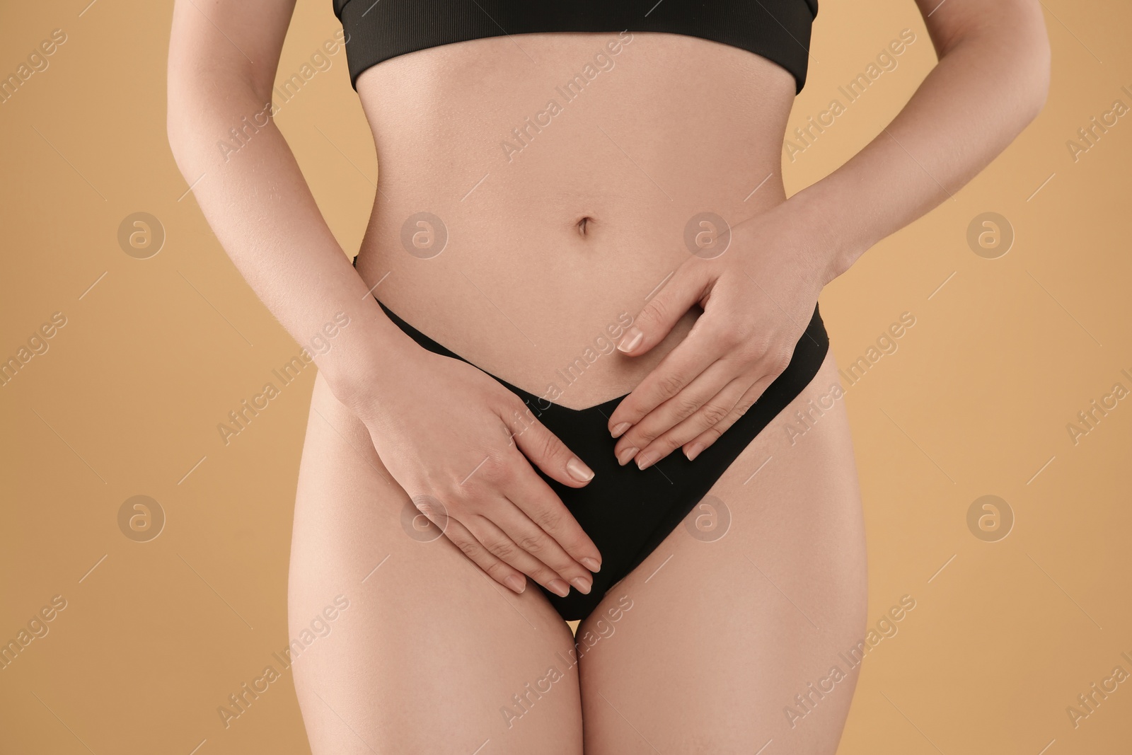 Photo of Gynecology. Woman in underwear on yellow background, closeup