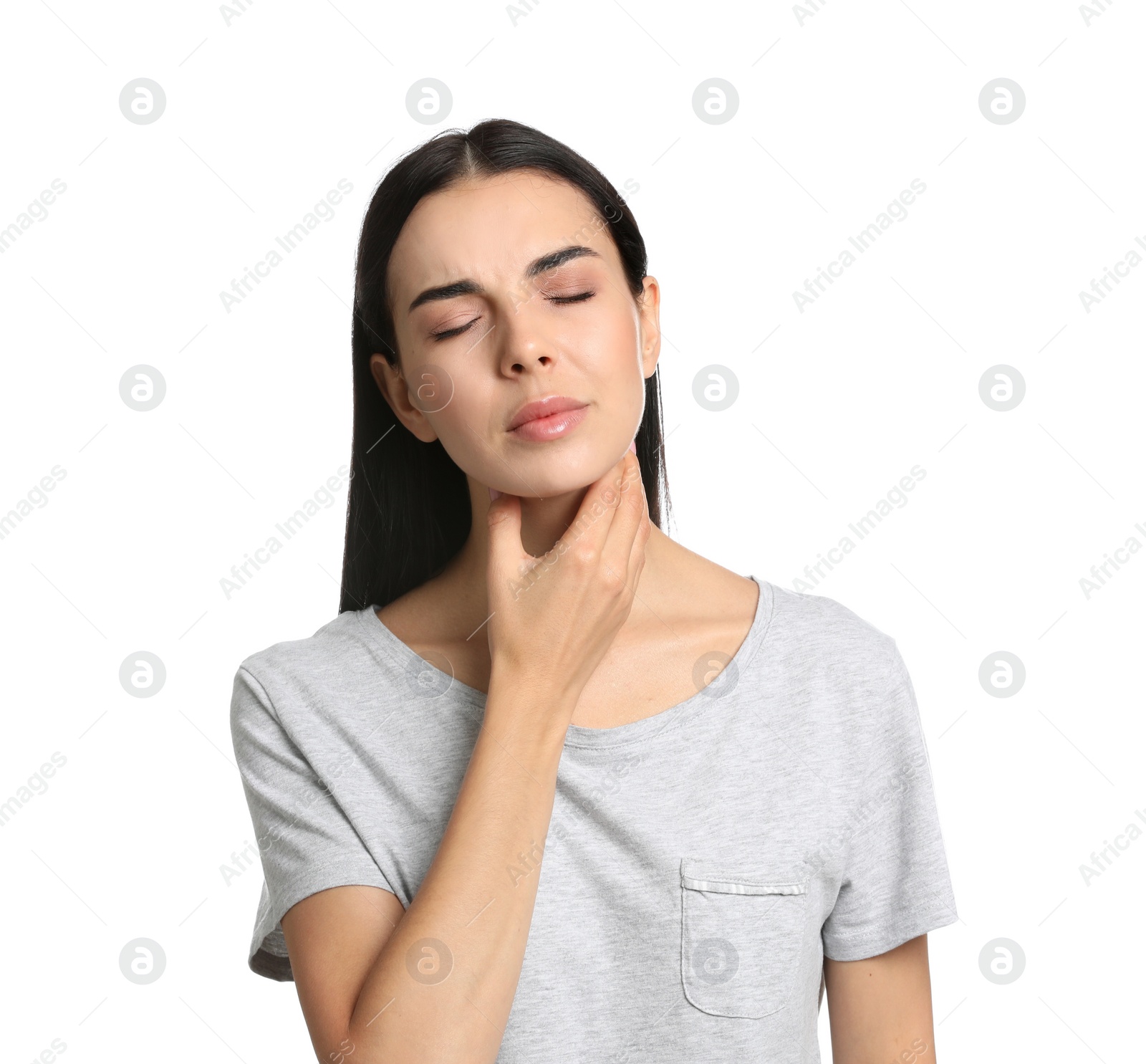 Photo of Young woman doing thyroid self examination on white background